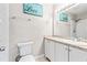 Bathroom features subway-tiled shower, toilet, and updated sink and vanity at 833 Lucerne Cir, Ormond Beach, FL 32174