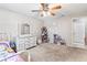 Bedroom with a ceiling fan, gray carpet, white dresser with mirror, and some decorations at 833 Lucerne Cir, Ormond Beach, FL 32174