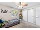 Bedroom featuring a ceiling fan, closet access, and carpeted flooring at 833 Lucerne Cir, Ormond Beach, FL 32174