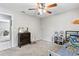 Neutral bedroom has a ceiling fan, closet access, and carpeted flooring at 833 Lucerne Cir, Ormond Beach, FL 32174