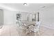 Open concept dining room with bright tile floors, rustic dining table, and neutral paint colors at 833 Lucerne Cir, Ormond Beach, FL 32174
