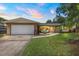 Charming home with a two-car garage, well-manicured lawn, and mature landscaping at 833 Lucerne Cir, Ormond Beach, FL 32174