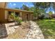 Inviting entrance with a brick-paved patio and a pathway leading to the front door at 833 Lucerne Cir, Ormond Beach, FL 32174