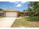 Charming single-story home featuring an attached garage, well-kept lawn, and inviting landscaping at 833 Lucerne Cir, Ormond Beach, FL 32174