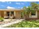 Cozy home exterior with a manicured lawn, complemented by trees and a clear sky at 833 Lucerne Cir, Ormond Beach, FL 32174