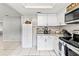 Bright and airy kitchen with white cabinetry and modern appliances, conveniently located at 833 Lucerne Cir, Ormond Beach, FL 32174