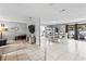 Open-concept living space with tile floors, neutral walls, a kitchen view, and access to the outdoor area at 833 Lucerne Cir, Ormond Beach, FL 32174