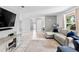 Bright living room featuring a large flat-screen TV, comfortable sectional sofa, and tile flooring at 833 Lucerne Cir, Ormond Beach, FL 32174