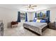 Comfortable main bedroom features soft carpet, a ceiling fan, and plenty of natural light at 833 Lucerne Cir, Ormond Beach, FL 32174