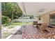 Covered patio with decorative tile, a ceiling fan, outdoor seating and a view of the backyard with a playset at 833 Lucerne Cir, Ormond Beach, FL 32174