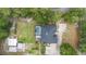 Aerial view of the property showcasing a pool, patio, and spacious yard surrounded by lush trees at 940 Glenwood Rd, Deland, FL 32720