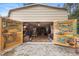 Interior of barn featuring open doors with artwork and well-organized storage shelves at 940 Glenwood Rd, Deland, FL 32720