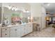 Bathroom featuring double vanity with white cabinetry, tile floors, and bright lighting fixtures at 940 Glenwood Rd, Deland, FL 32720