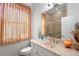 Bathroom with a single sink vanity, an adjacent toilet, and a glass shower, all well-lit at 940 Glenwood Rd, Deland, FL 32720