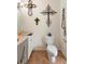 Cozy bathroom with decorative crosses, white vanity, and neutral flooring at 940 Glenwood Rd, Deland, FL 32720