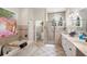 Bright bathroom features a soaking tub, glass shower, and double vanity with white cabinetry at 940 Glenwood Rd, Deland, FL 32720