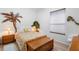 Bedroom features a palm tree wall hanging and a wooden chest at the foot of the bed at 940 Glenwood Rd, Deland, FL 32720