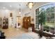 Bright foyer featuring tile flooring, large windows, and stylish light fixtures at 940 Glenwood Rd, Deland, FL 32720