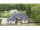 Well-maintained home with a black roof, elegant front door, and inviting landscaping at 940 Glenwood Rd, Deland, FL 32720