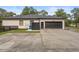 Exterior view of the home featuring a paved driveway leading to a spacious two-car garage at 940 Glenwood Rd, Deland, FL 32720