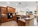 Kitchen featuring wooden cabinets, gas range, and open access to the living room at 940 Glenwood Rd, Deland, FL 32720