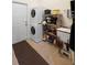 Bright laundry room with stackable washer and dryer, storage shelves, and a utility sink at 940 Glenwood Rd, Deland, FL 32720