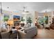 Bright living room with fireplace, ceiling fan, and sliding glass doors to lanai at 940 Glenwood Rd, Deland, FL 32720