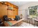Home office featuring wood paneling, built-in shelving, and a bright window at 940 Glenwood Rd, Deland, FL 32720