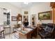 Spacious home office with a large wooden desk, bright windows, and elegant decor at 940 Glenwood Rd, Deland, FL 32720