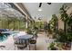 Screened-in patio with a pool, various seating areas, and an abundance of plants and greenery at 940 Glenwood Rd, Deland, FL 32720