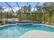 A screened-in pool area with clear blue water, tiled accents, and comfortable seating at 940 Glenwood Rd, Deland, FL 32720