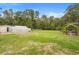 A view of the large property showing the home, lawn, garden, greenhouse, and outbuildings on a sunny day at 940 Glenwood Rd, Deland, FL 32720