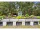 A long raised garden bed constructed from painted cinder blocks, with a shed and greenery in the background at 940 Glenwood Rd, Deland, FL 32720