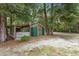 A well built metal shed in the yard with a wood enclosure attached, stacked with cut firewood at 940 Glenwood Rd, Deland, FL 32720