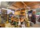 A messy, cluttered workshop containing a wooden workbench, toolboxes, storage containers, and various tools at 940 Glenwood Rd, Deland, FL 32720