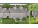 A captivating aerial view showcases the building's unique roof design surrounded by lush greenery and manicured landscaping at 944 Regatta Bay Dr # 12-102, Orange City, FL 32763