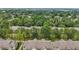 An aerial view of a housing community surrounded by mature trees and lush landscaping at 944 Regatta Bay Dr # 12-102, Orange City, FL 32763