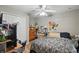 A secondary bedroom featuring a ceiling fan, desk, and closet with white doors at 944 Regatta Bay Dr # 12-102, Orange City, FL 32763