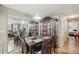 Dining area with seating for six, mirrored wall, dark wood table, and hardwood floors at 944 Regatta Bay Dr # 12-102, Orange City, FL 32763