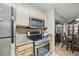 A kitchen with stainless steel appliances, granite counters, and an adjacent dining area at 944 Regatta Bay Dr # 12-102, Orange City, FL 32763