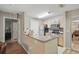 Well-lit kitchen featuring granite countertops and stainless-steel appliances with hardwood floors at 944 Regatta Bay Dr # 12-102, Orange City, FL 32763