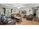 Bright living room boasting hardwood floors, comfortable seating, and a large mounted TV at 944 Regatta Bay Dr # 12-102, Orange City, FL 32763