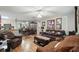 Spacious living room showcasing hardwood floors, dark leather furniture, and decorative accents at 944 Regatta Bay Dr # 12-102, Orange City, FL 32763