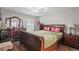 Spacious main bedroom with a ceiling fan, wood floors, and a large dresser at 944 Regatta Bay Dr # 12-102, Orange City, FL 32763
