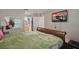 View of main bedroom with wood floors, TV, ceiling fan, and ensuite bath at 944 Regatta Bay Dr # 12-102, Orange City, FL 32763