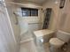 Shower with built-in seat, grab bars, and tiled walls for accessibility and safety at 96 Old Barn Trl, Ormond Beach, FL 32174