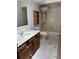 Bright bathroom featuring wooden vanity, classic fixtures, and a shower-tub combo at 96 Old Barn Trl, Ormond Beach, FL 32174