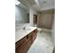 Bright bathroom featuring a wooden vanity, classic fixtures, and a shower-tub combo at 96 Old Barn Trl, Ormond Beach, FL 32174