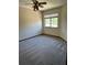 Bright bedroom featuring neutral carpeting, large windows, and a ceiling fan at 96 Old Barn Trl, Ormond Beach, FL 32174