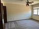 Well-lit bedroom showcases a ceiling fan and window with natural light and classic bi-fold closet doors at 96 Old Barn Trl, Ormond Beach, FL 32174